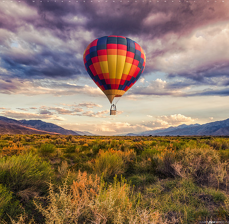 Hot Air Balloon flying over a valley